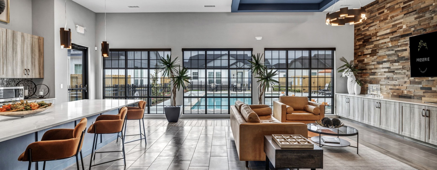 Spacious community kitchen with large windows with a view of the pool 